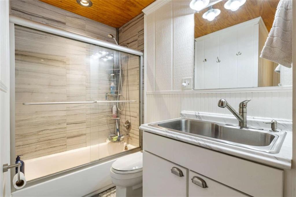5948 Haywood Valley Road Summerville, GA 30747 - Photo 14 of 74 a bathroom with a sink and a bathtub