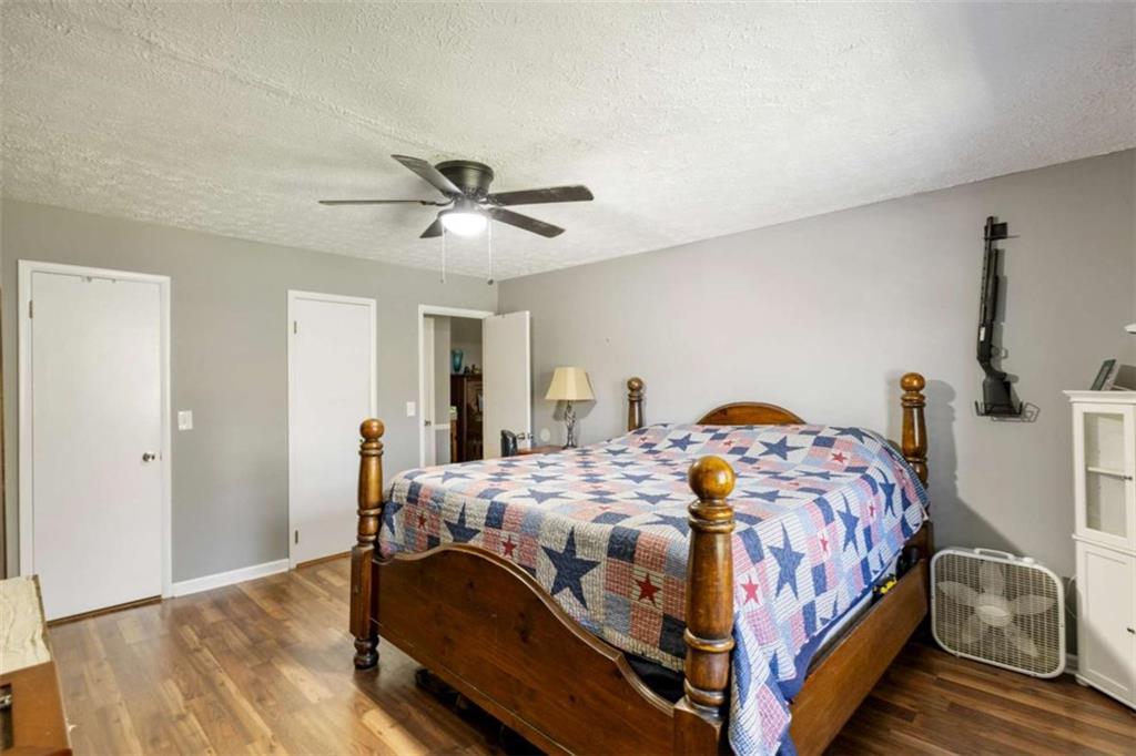 5948 Haywood Valley Road Summerville, GA 30747 - Photo 15 of 74 a bedroom with a bed and a chandelier