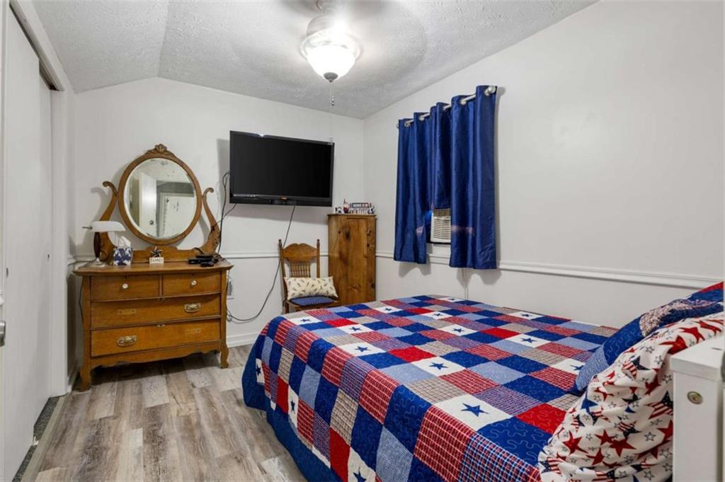 5948 Haywood Valley Road Summerville, GA 30747 - Photo 16 of 74 a bedroom with a bed and a flat screen tv