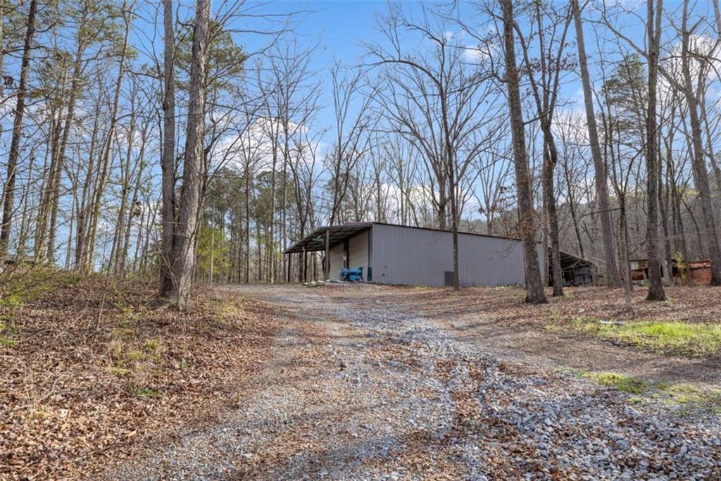 5948 Haywood Valley Road Summerville, GA 30747 - Photo 64 of 74 a backyard of a house with large trees and wooden fence