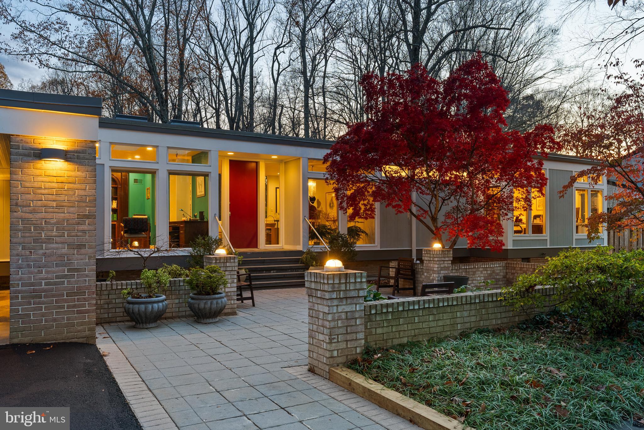 a view of house with backyard and outdoor seating