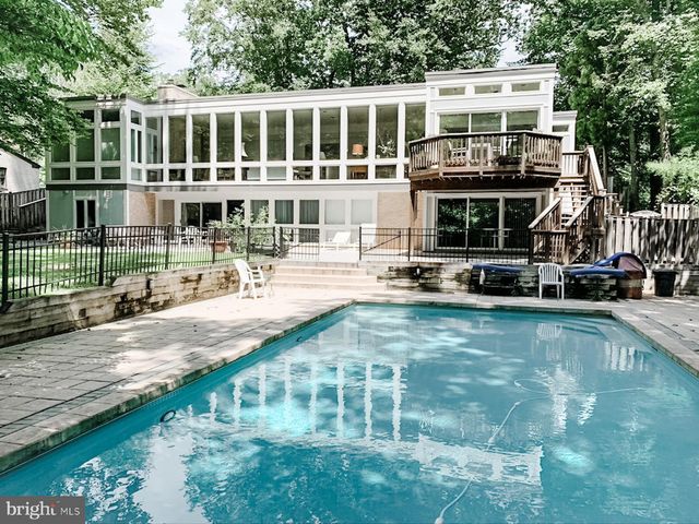 a front view of a building with a garden and plants