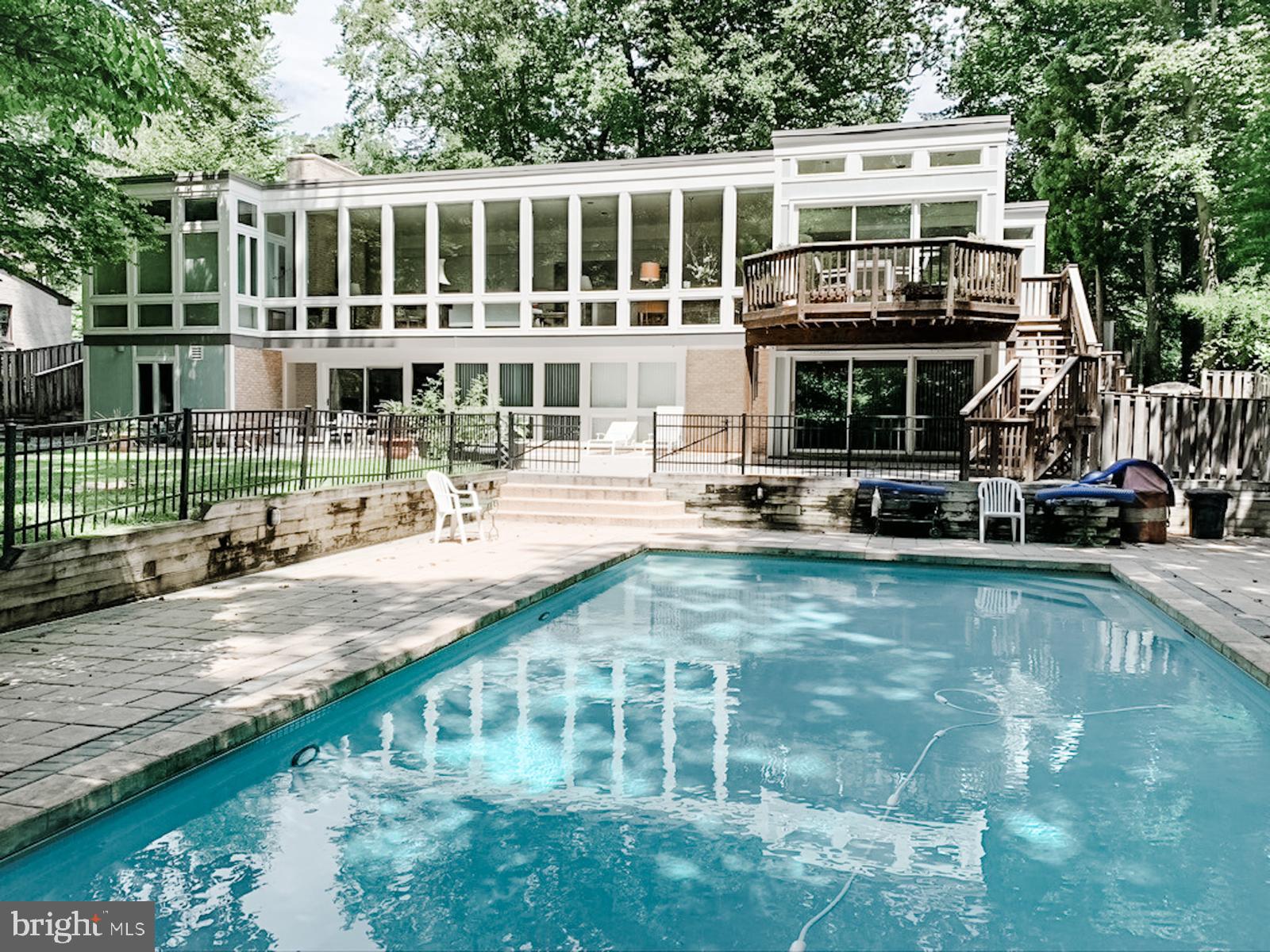 6904 Carmichael Avenue Bethesda, MD 20817 - Photo 9 of 16 a front view of a building with a garden and plants