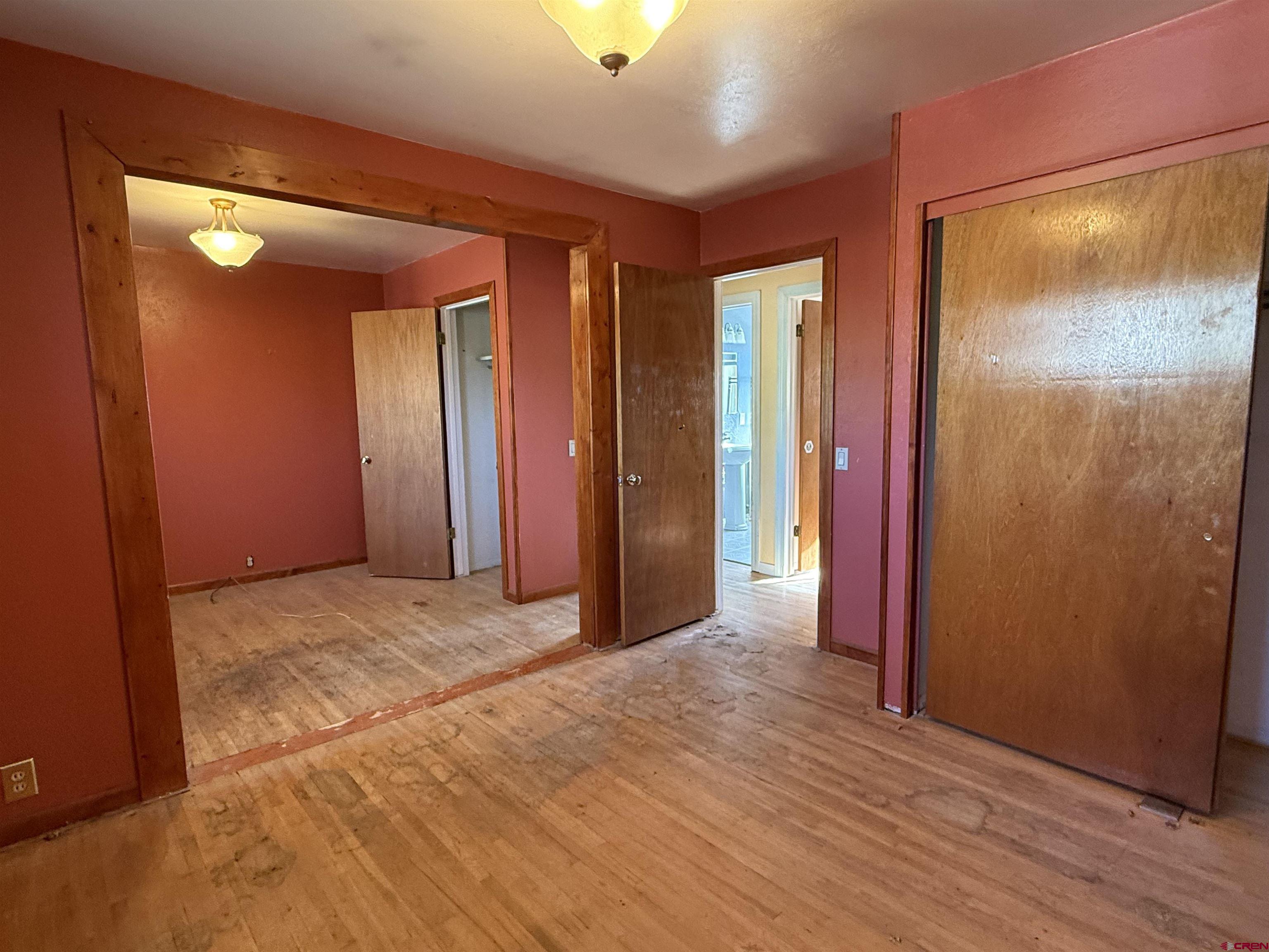 418 South Valley Road Cortez, CO 81321 - Photo 11 of 32 an empty room with wooden floor and windows