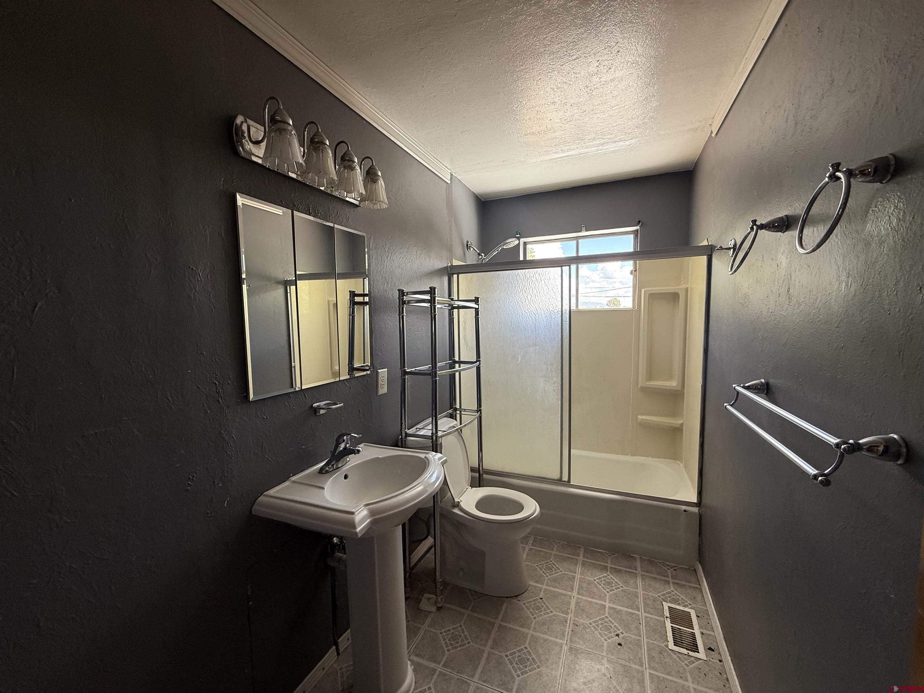 418 South Valley Road Cortez, CO 81321 - Photo 13 of 32 a bathroom with a sink mirror toilet and shower
