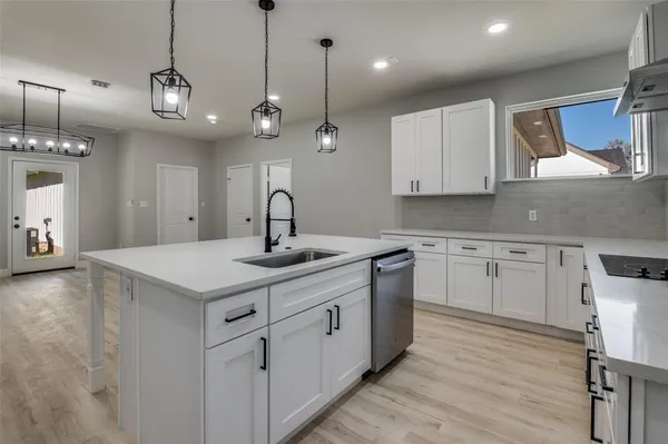 a kitchen with a sink stove and cabinets