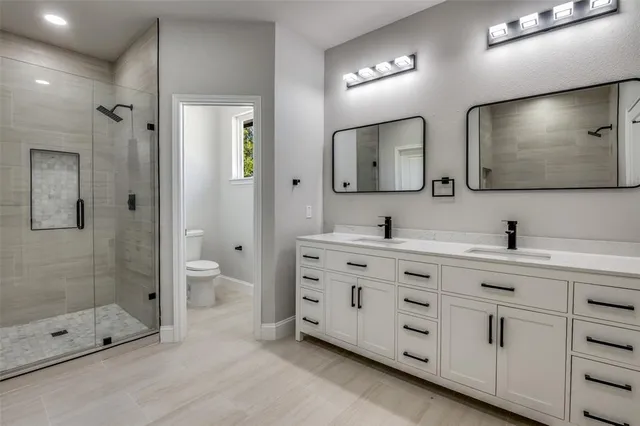 a bathroom with double sink and a mirror
