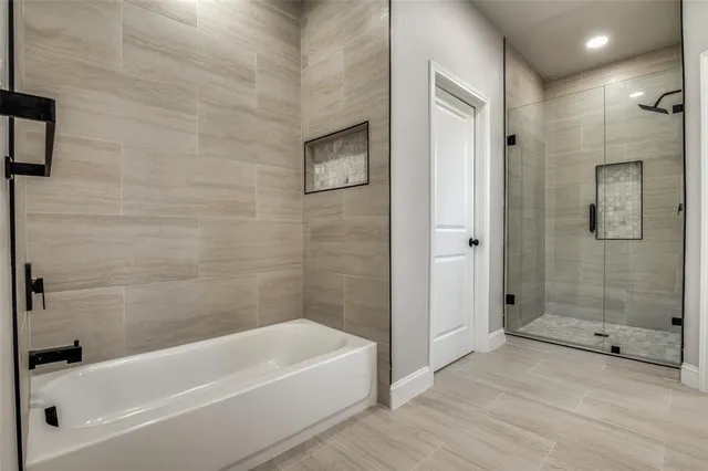 a bathroom with a bathtub and a shower