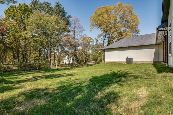 a yard with trees in front of it