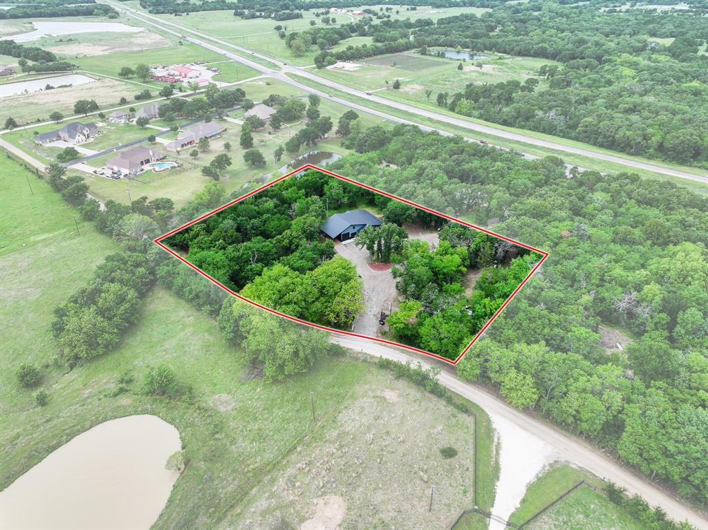1900 County Road 1535 Bonham, TX 75418 - Photo 2 of 37 a view of a green yard with a fountain