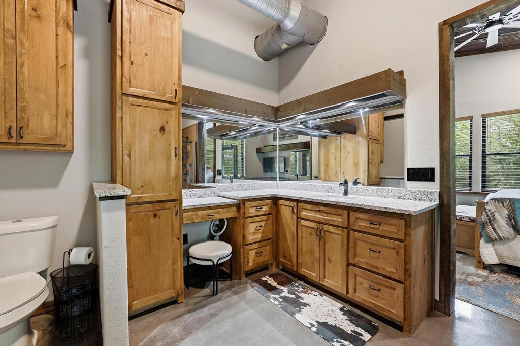 1900 County Road 1535 Bonham, TX 75418 - Photo 21 of 37 a bathroom with a granite countertop toilet sink and mirror