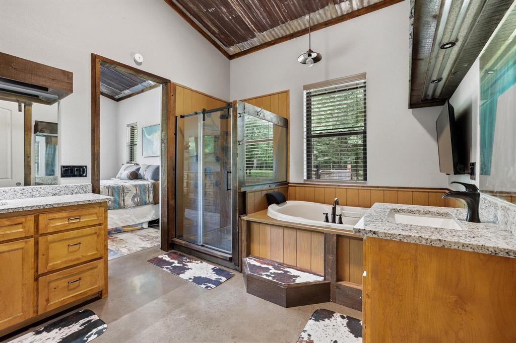 1900 County Road 1535 Bonham, TX 75418 - Photo 22 of 37 a bathroom with a granite countertop sink and a large mirror