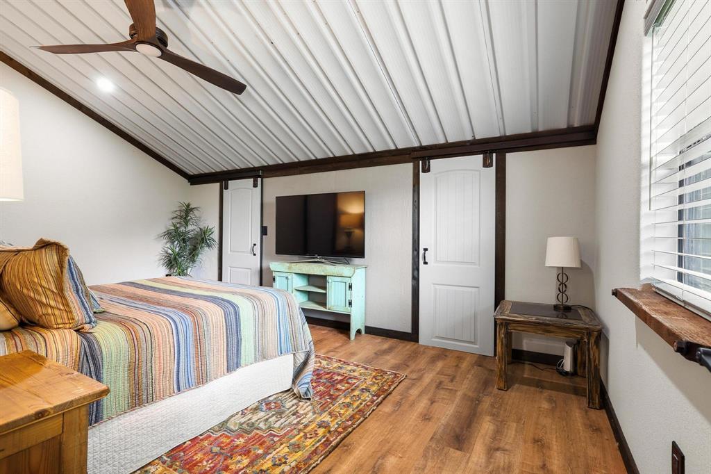 1900 County Road 1535 Bonham, TX 75418 - Photo 32 of 37 a bedroom with double bed a flat tv screen and a window