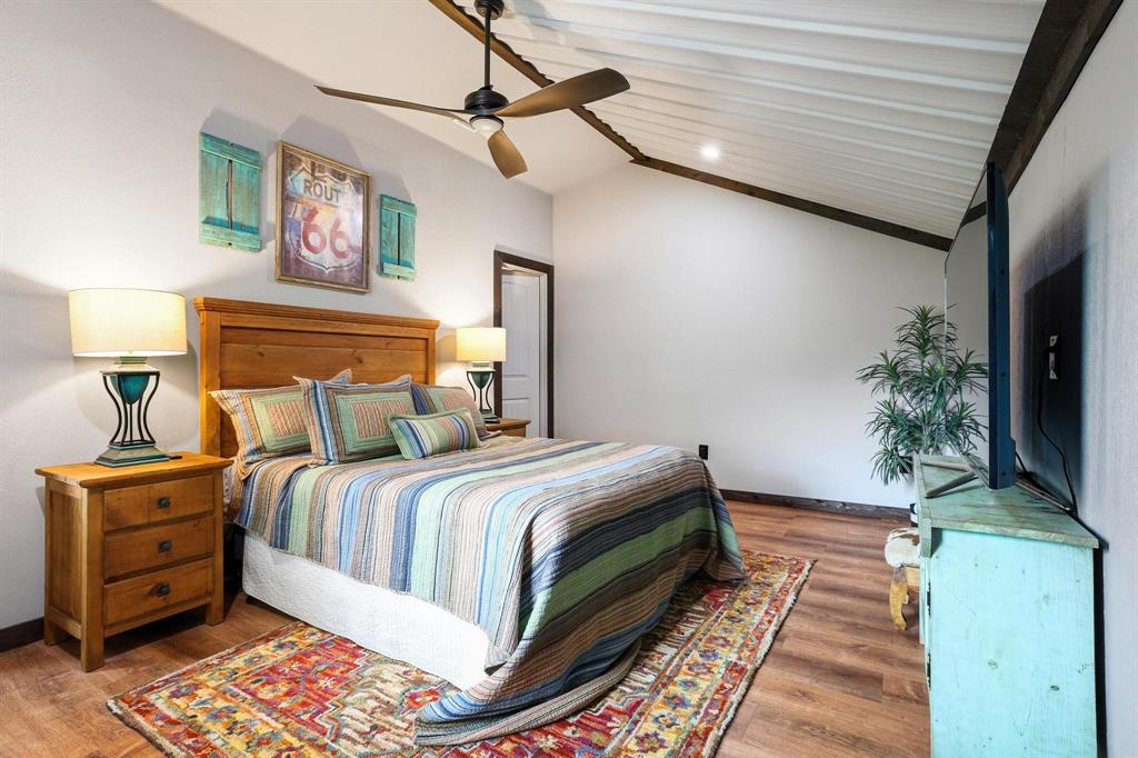 1900 County Road 1535 Bonham, TX 75418 - Photo 33 of 37 a bed sitting in a bedroom next to a lamp