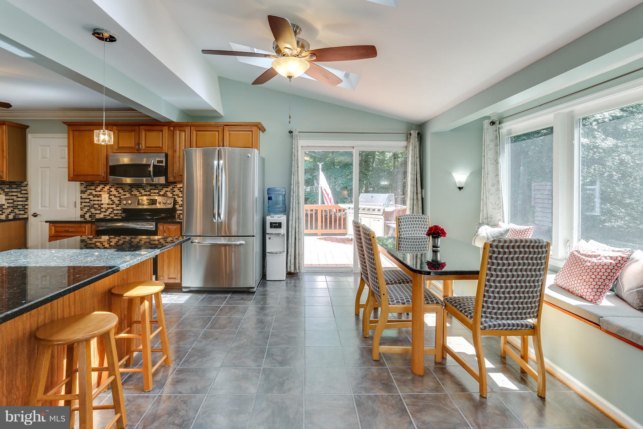 190 Hickory Point Road Pasadena, MD 21122 - Photo 4 of 30 Kitchen with breakfast area leading to deck