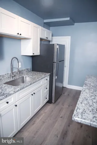 a kitchen with stainless steel appliances granite countertop a refrigerator sink and cabinets