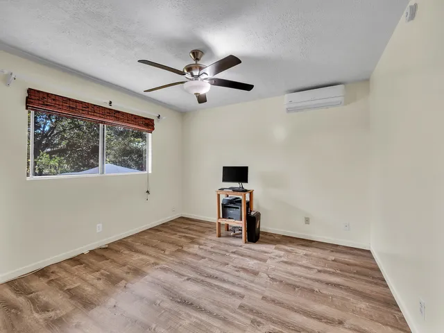 a view of hallway with livingroom and wooden floor