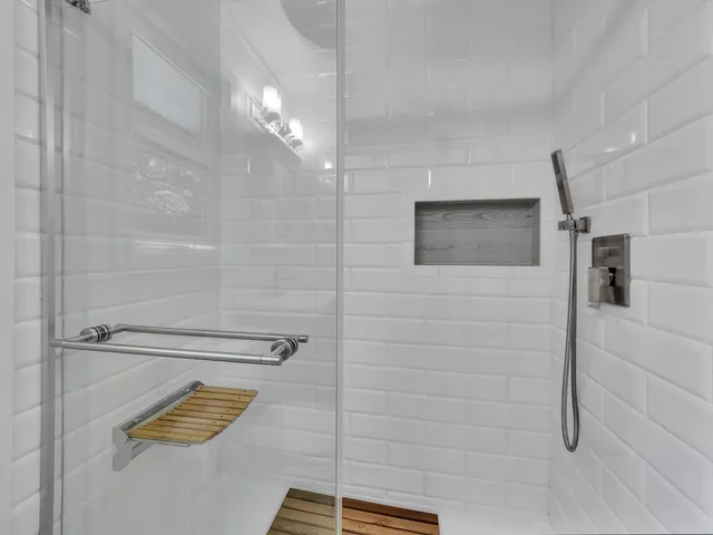 a view of a livingroom with a ceiling fan window and wooden floor