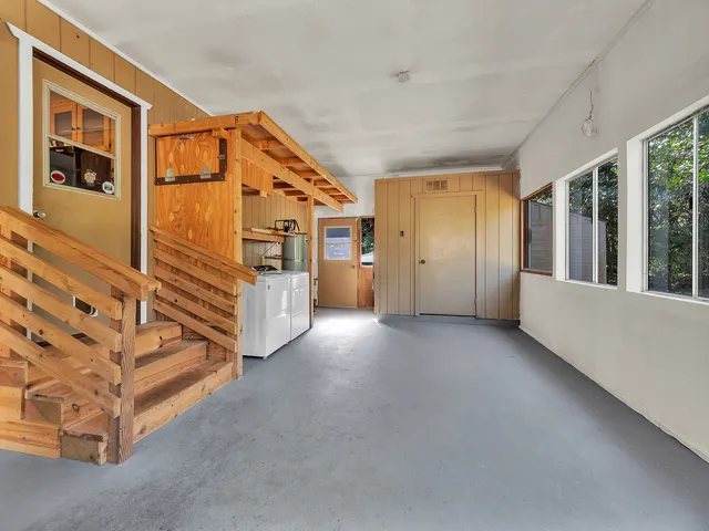 a view of hallway with furniture and windows