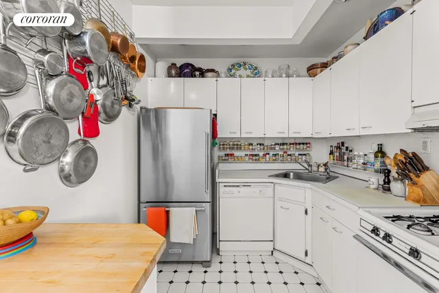 a kitchen with stainless steel appliances a refrigerator sink and cabinets