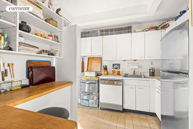 a kitchen with cabinets appliances and a window
