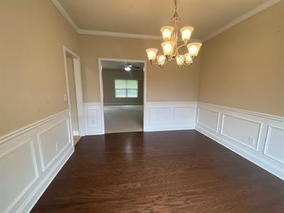 3829 Baxley Ridge Drive Suwanee, GA 30024 - Photo 3 of 11 a view of a livingroom with a chandelier fan and wooden floor