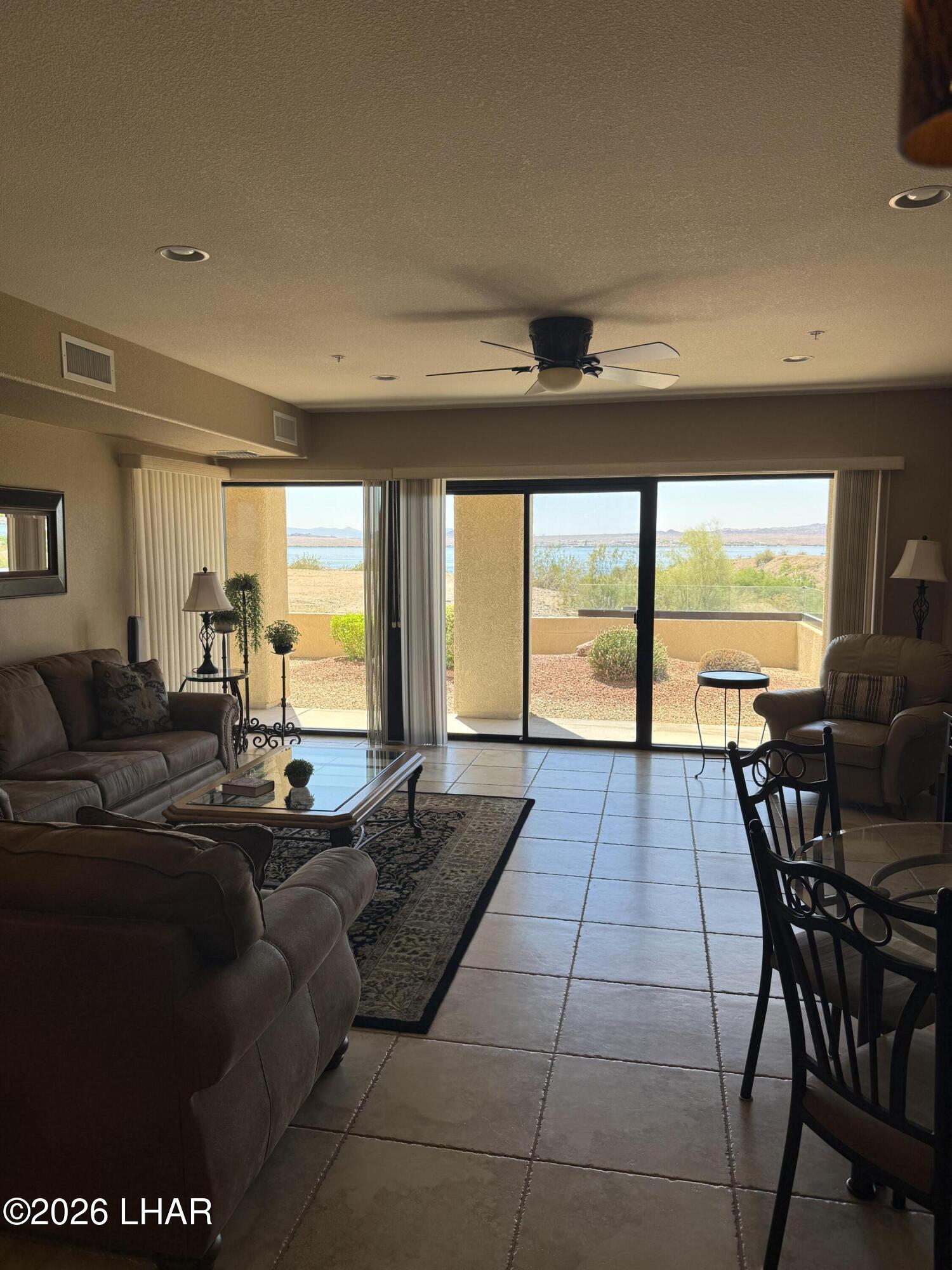 433 London Bridge Road, Unit B101 Lake Havasu City, AZ 86403 - Photo 16 of 35 a living room with furniture and large windows