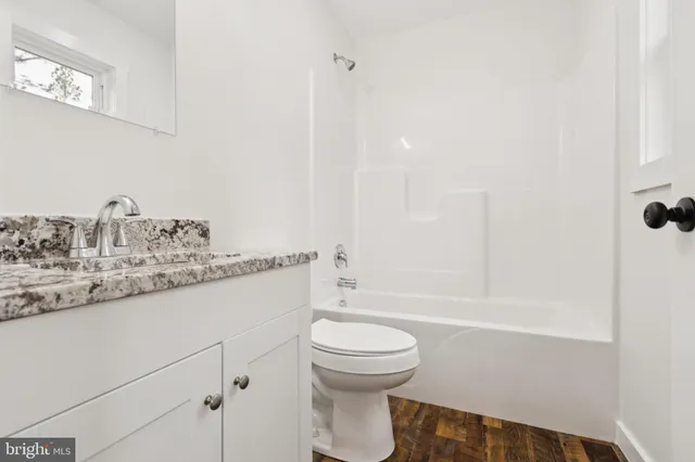 a bathroom with a sink a toilet and a bathtub