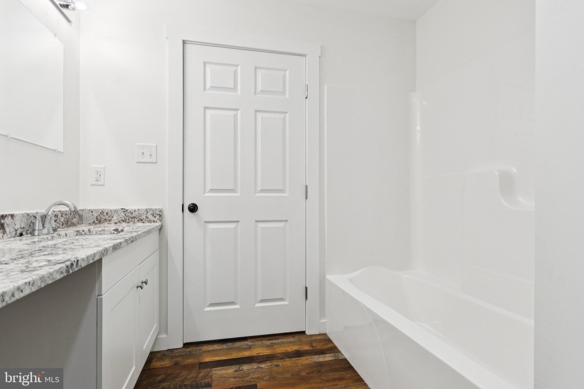 15281 Shirley Road Unionville, VA 22567 - Photo 14 of 24 a bathroom with a granite countertop sink and a bathtub