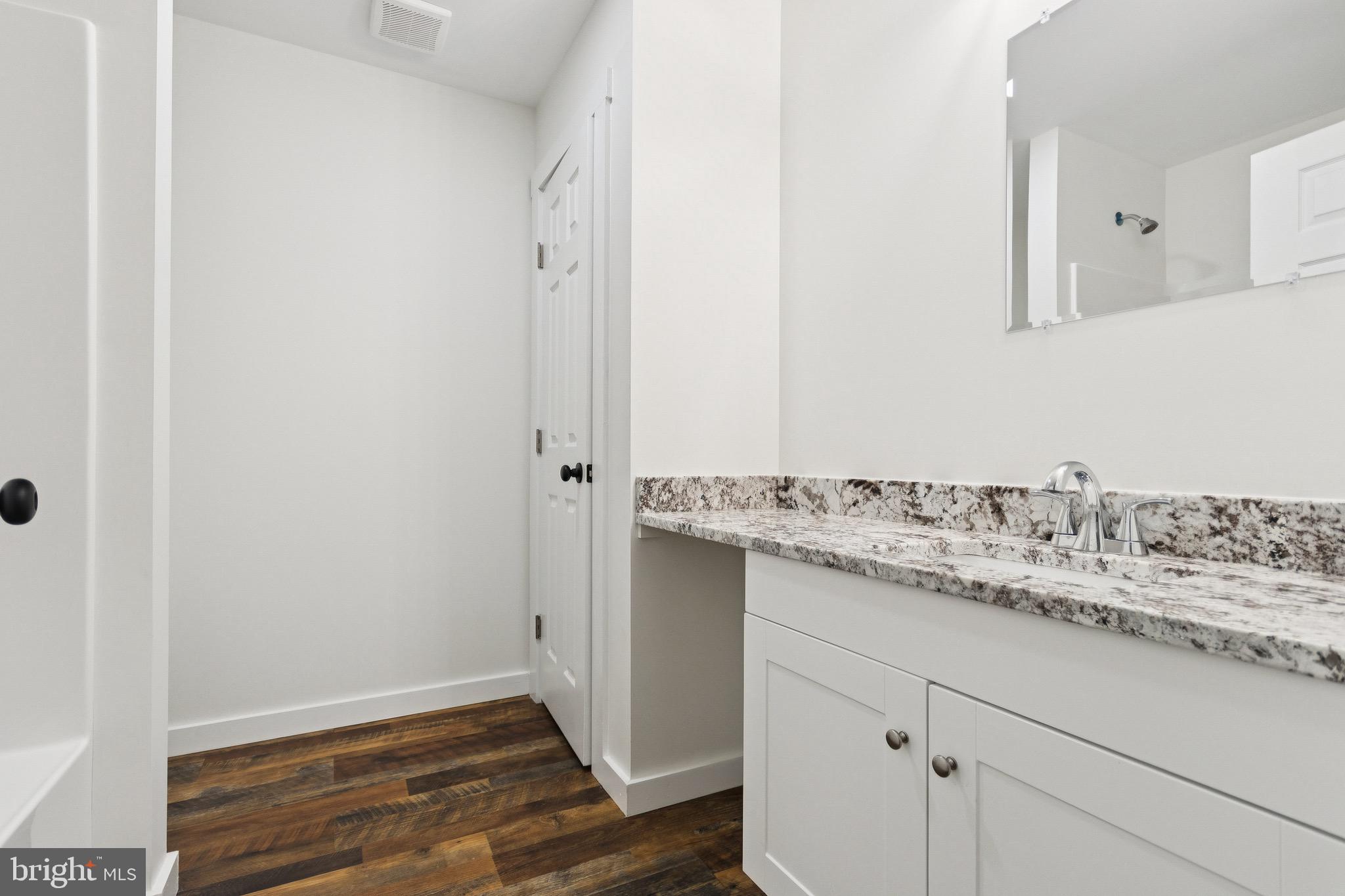 15281 Shirley Road Unionville, VA 22567 - Photo 16 of 24 a bathroom with a granite countertop sink and a mirror