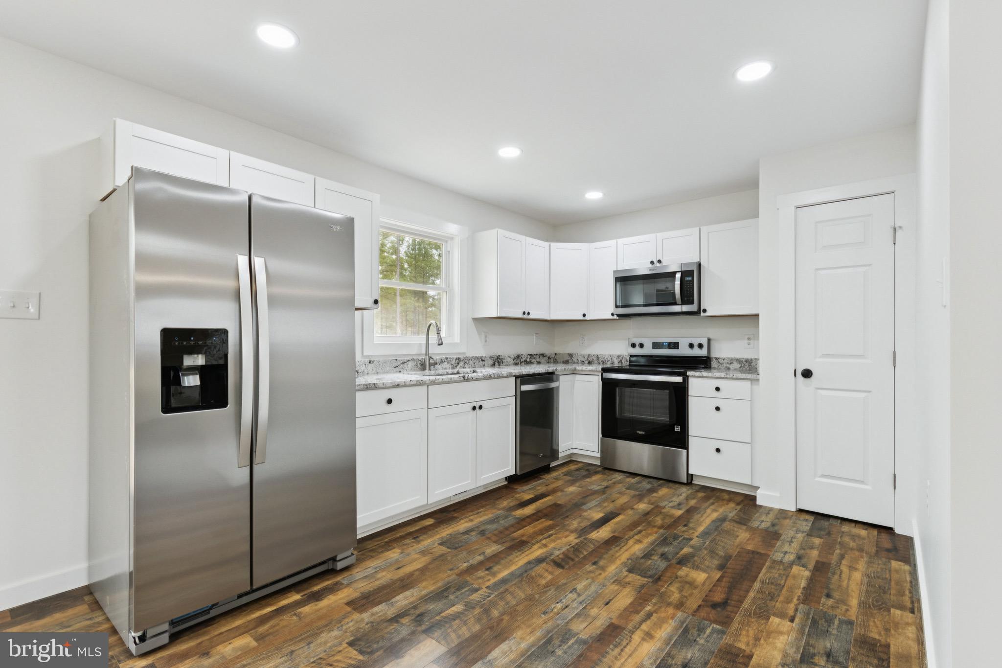 15281 Shirley Road Unionville, VA 22567 - Photo 3 of 24 a kitchen with a refrigerator a sink and cabinets
