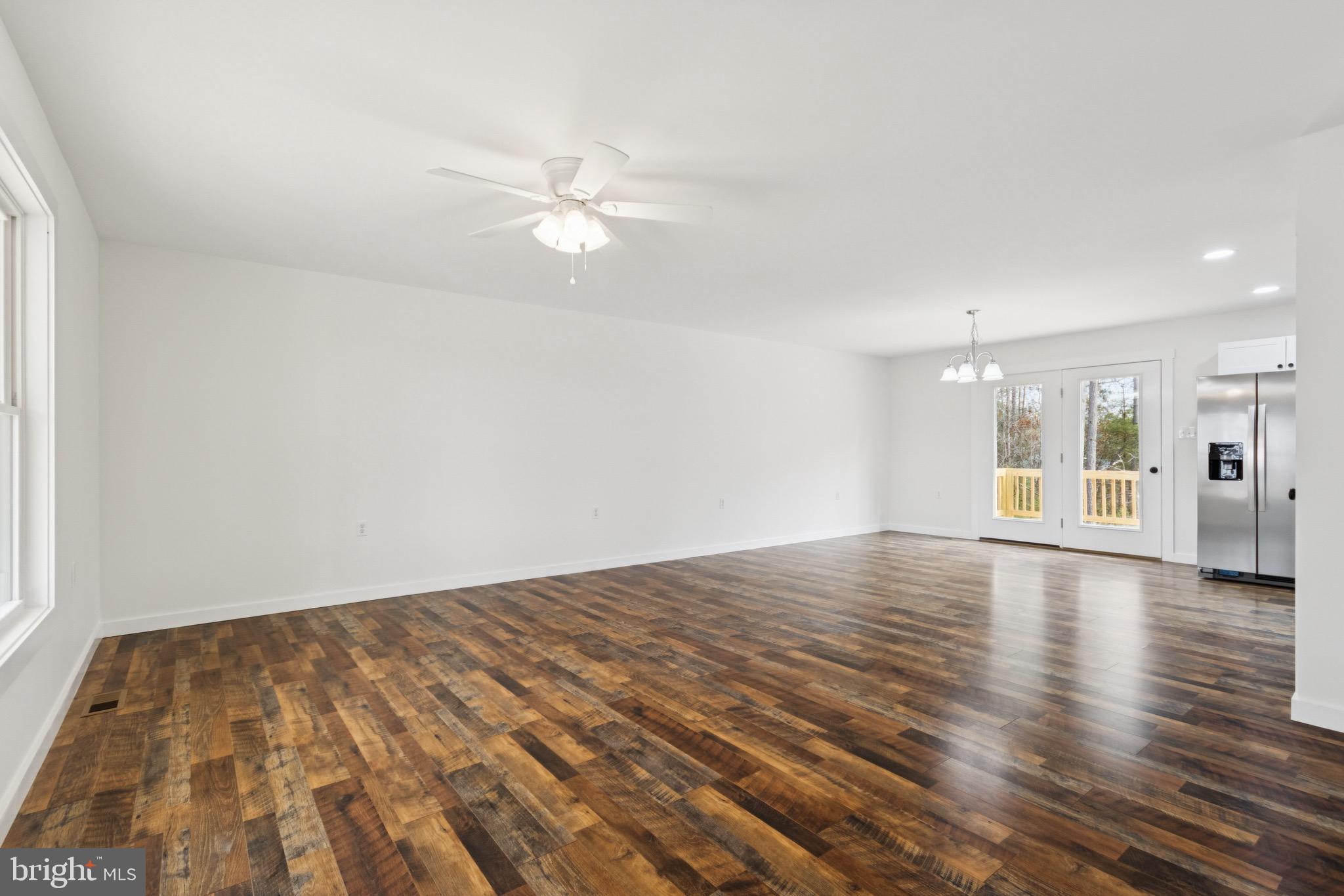 15281 Shirley Road Unionville, VA 22567 - Photo 8 of 24 a view of empty room with wooden floor and fan