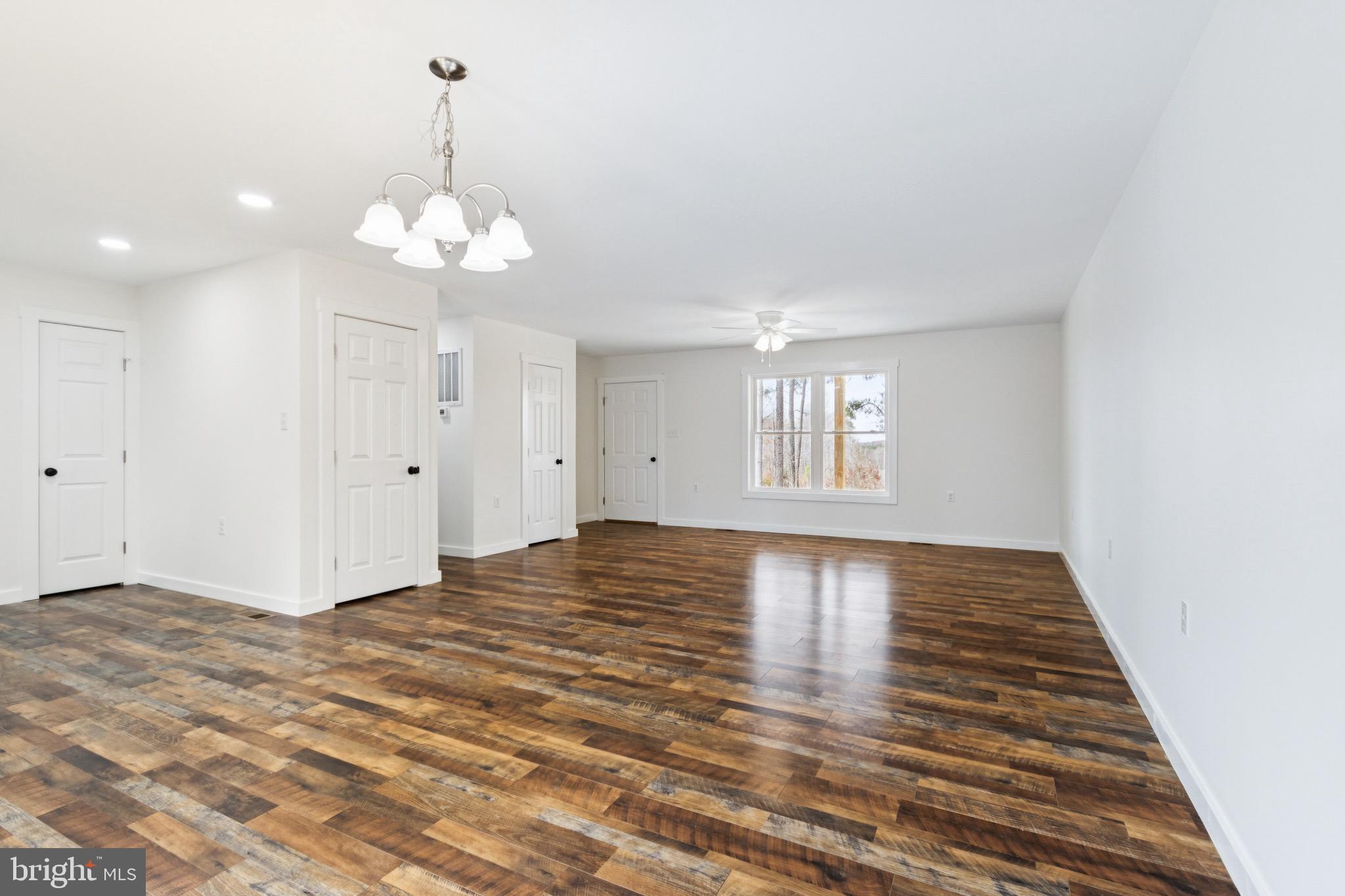 15281 Shirley Road Unionville, VA 22567 - Photo 9 of 24 a view of an empty room with wooden floor and a window