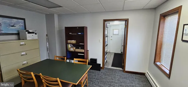 a room with table chairs and wooden floor