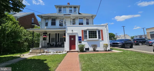 a front view of a house with a yard table and chairs