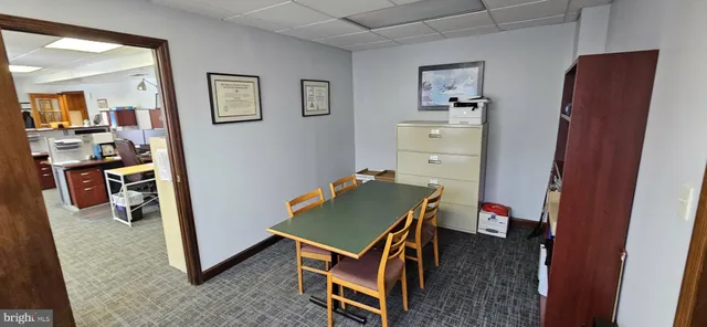 a room with a wooden floor and a stove top oven