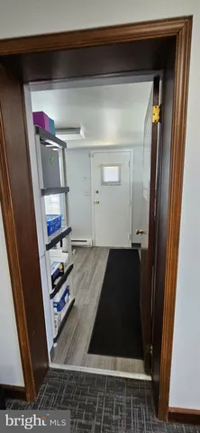 a room with wooden floor and furniture