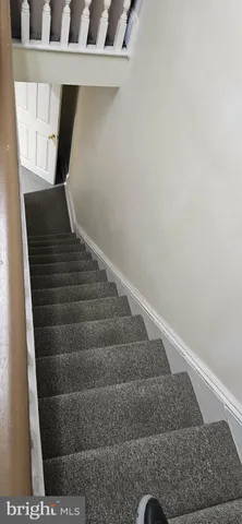 a living room with dining room and kitchen view
