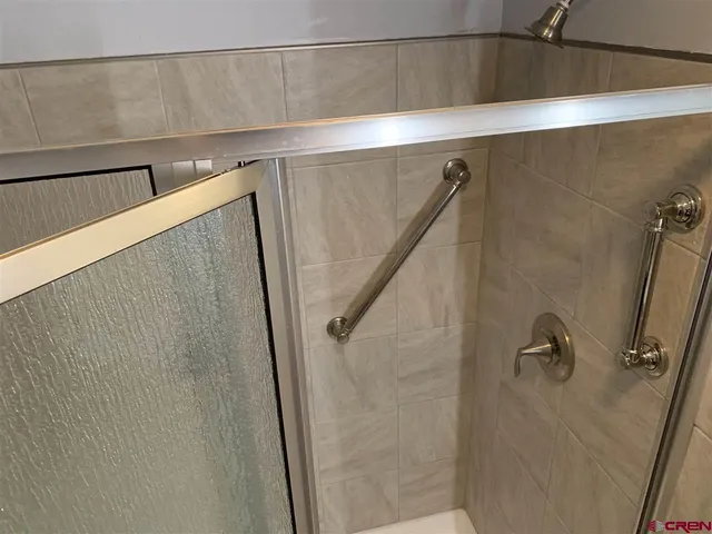 a bathroom with a shower and a sink