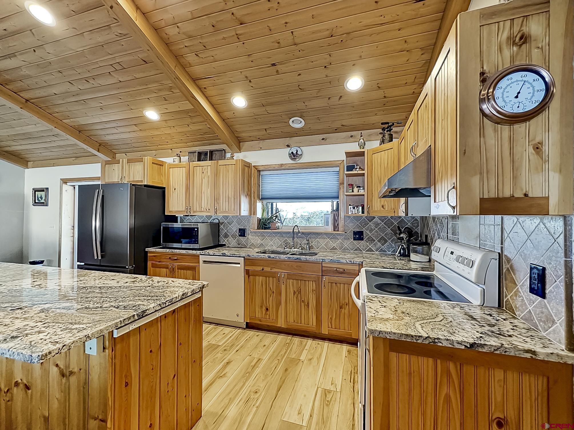 38832 Fruitland Mesa Road Crawford, CO 81415 - Photo 6 of 41 a kitchen with stainless steel appliances granite countertop a sink stove and refrigerator