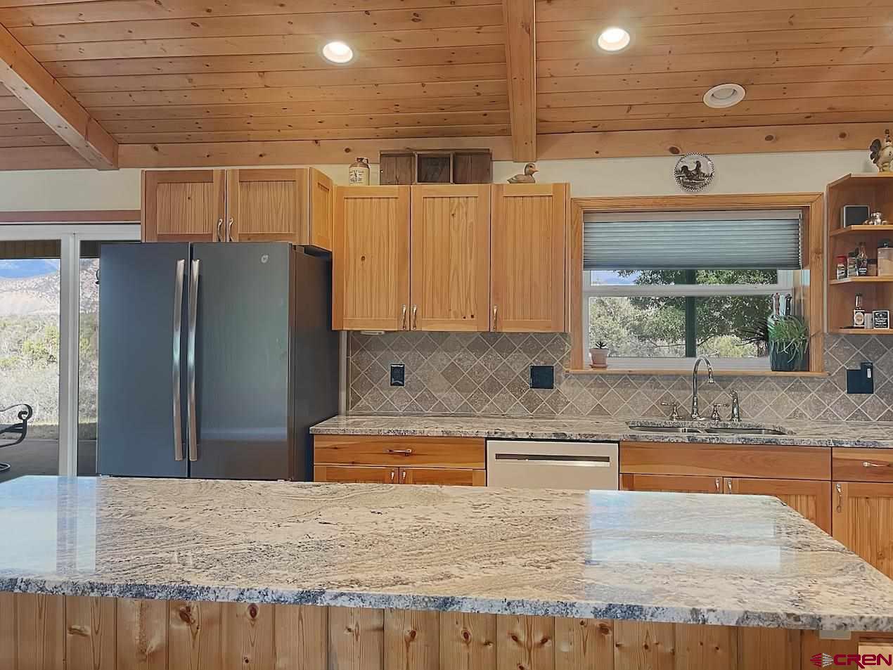 38832 Fruitland Mesa Road Crawford, CO 81415 - Photo 7 of 41 a kitchen with stainless steel appliances granite countertop wooden cabinets and a granite counter tops