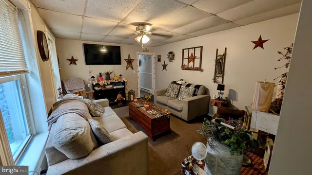 a living room with furniture and a flat screen tv
