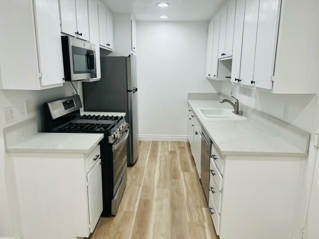 511 D Street Upland, CA 91786 - Photo 6 of 8 a kitchen with a sink a stove and refrigerator