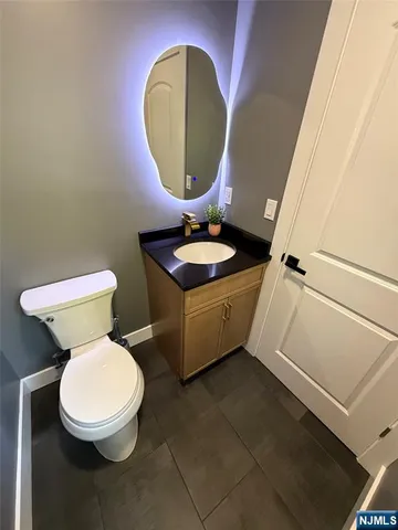 a large bedroom with a large bed and a flat tv screen on dresser