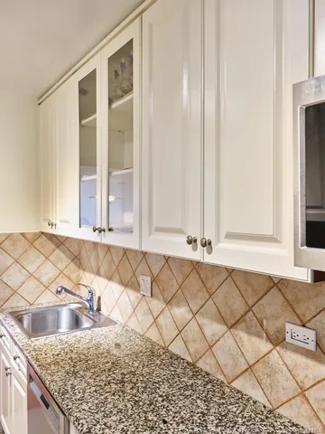 a view of a kitchen that has a sink and a window