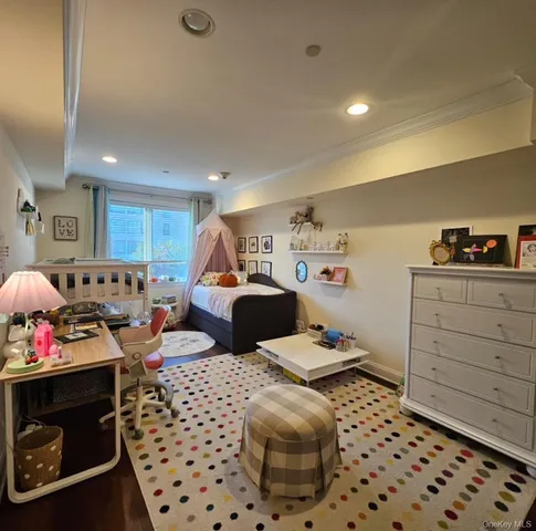 a bedroom with furniture a baby crib and a dresser