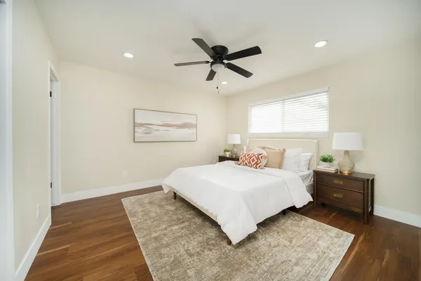 a bedroom with a bed and a night stand