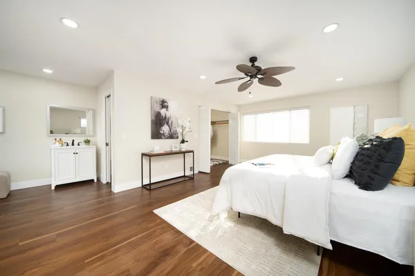 a bedroom with a bed and a ceiling fan