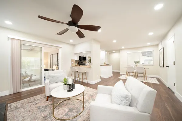 a living room with furniture and a wooden floor