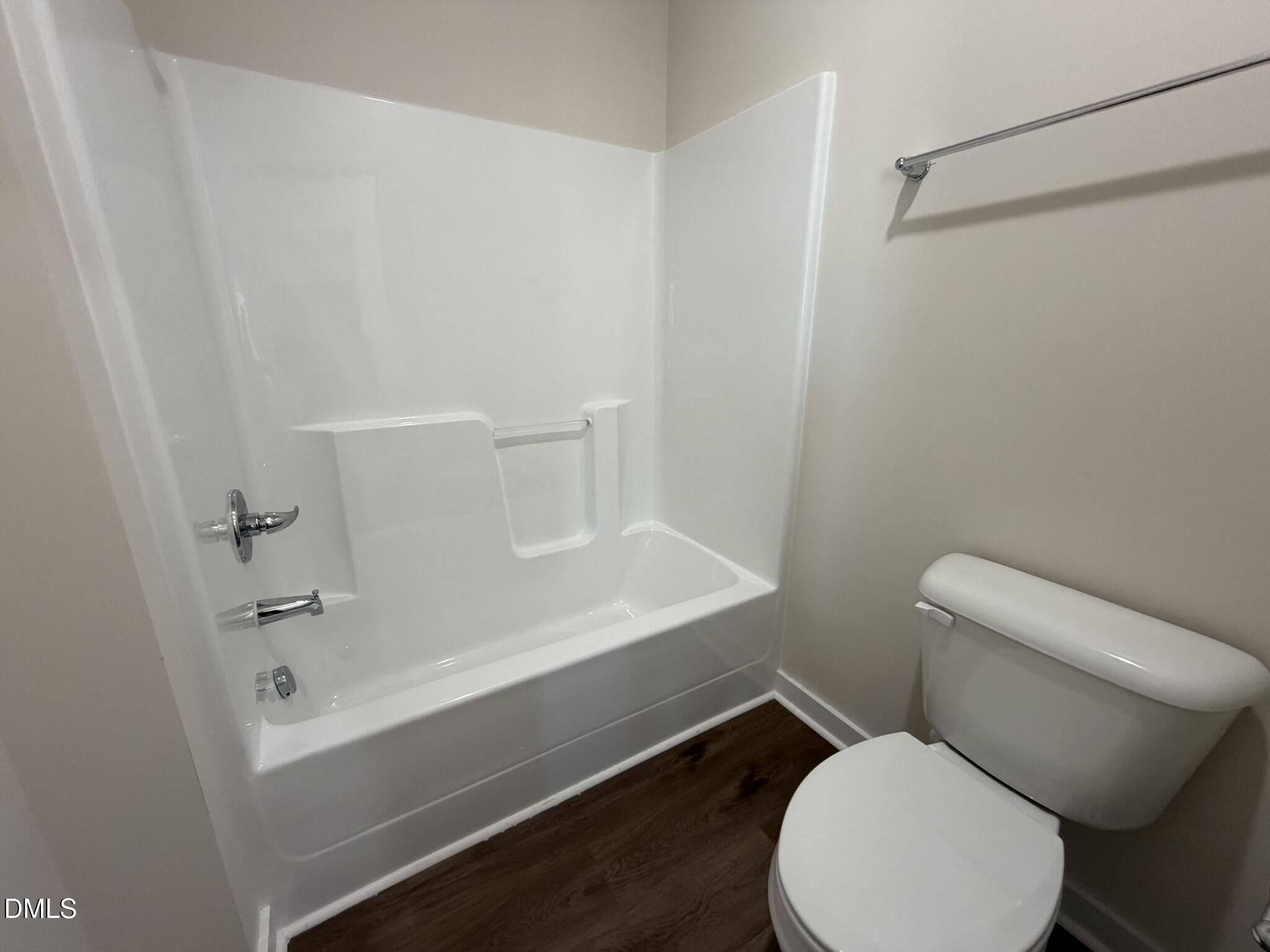 159 Jacobs Ridge Drive Four Oaks, NC 27524 - Photo 12 of 18 a white toilet sitting next to a bath tub